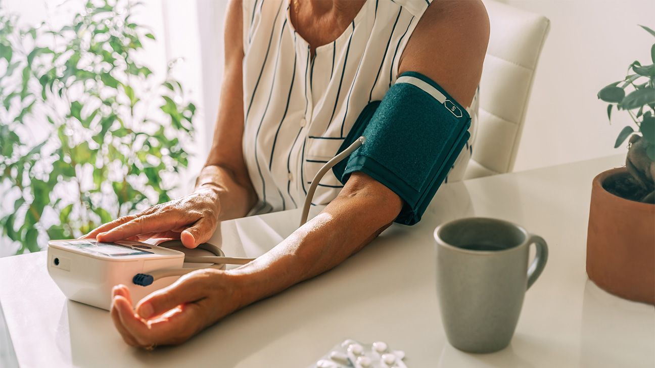 Female checking her blood pressure with a BP cuff
