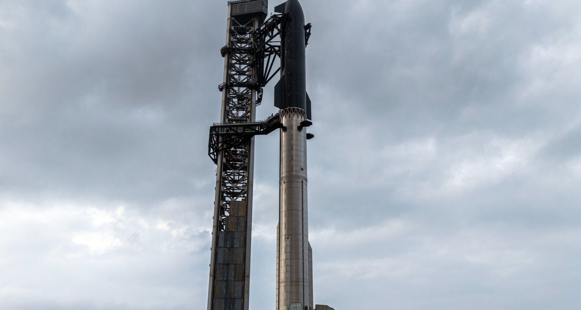 SpaceX Starship Flight 12 stands atop launch pad before May 2026 test flight under cloudy skies