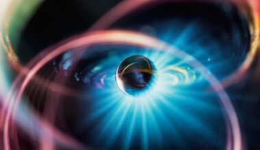 An illustration of a metal sphere surrounded by various colors and a glow of blue light.