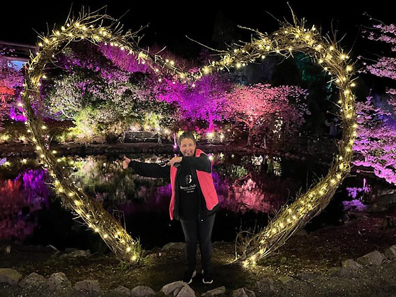 Fiona Rammell in amongst the blossoms. // Photo credit: Awanui NZ