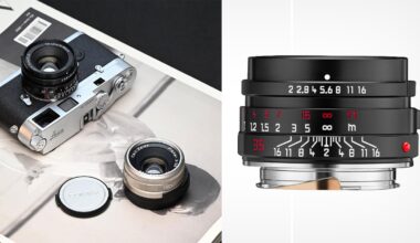 A Leica film camera with a mounted lens sits on a magazine beside a silver lens and a lens cap. Next to it is a close-up of a camera lens showing detailed focus and aperture markings.