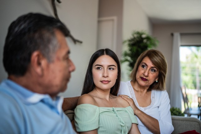 Family talking in the living room at home