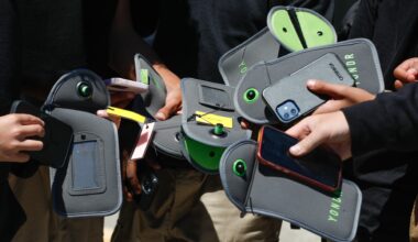They started popping up in schools. Now, they’re showing up in the workplace. Cellphone bans and locked phone pouches are gaining popularity.