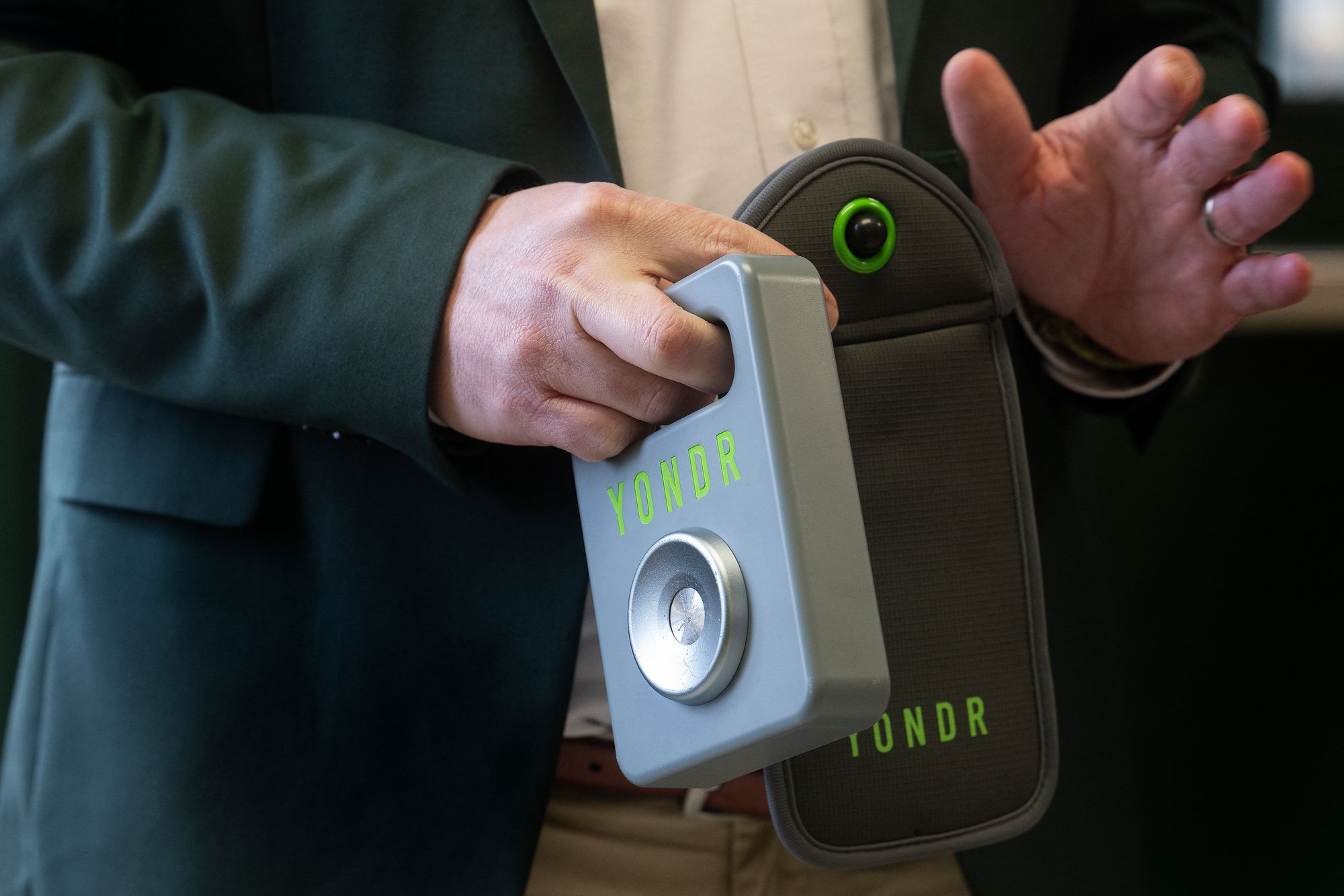 Mark Twain Middle School Principal Matthew Mough holds a Yondr pouch in Alexandria, Virginia, in March 2025. Schools that used the pouches saw daily cellphone pings fall by 30 percent