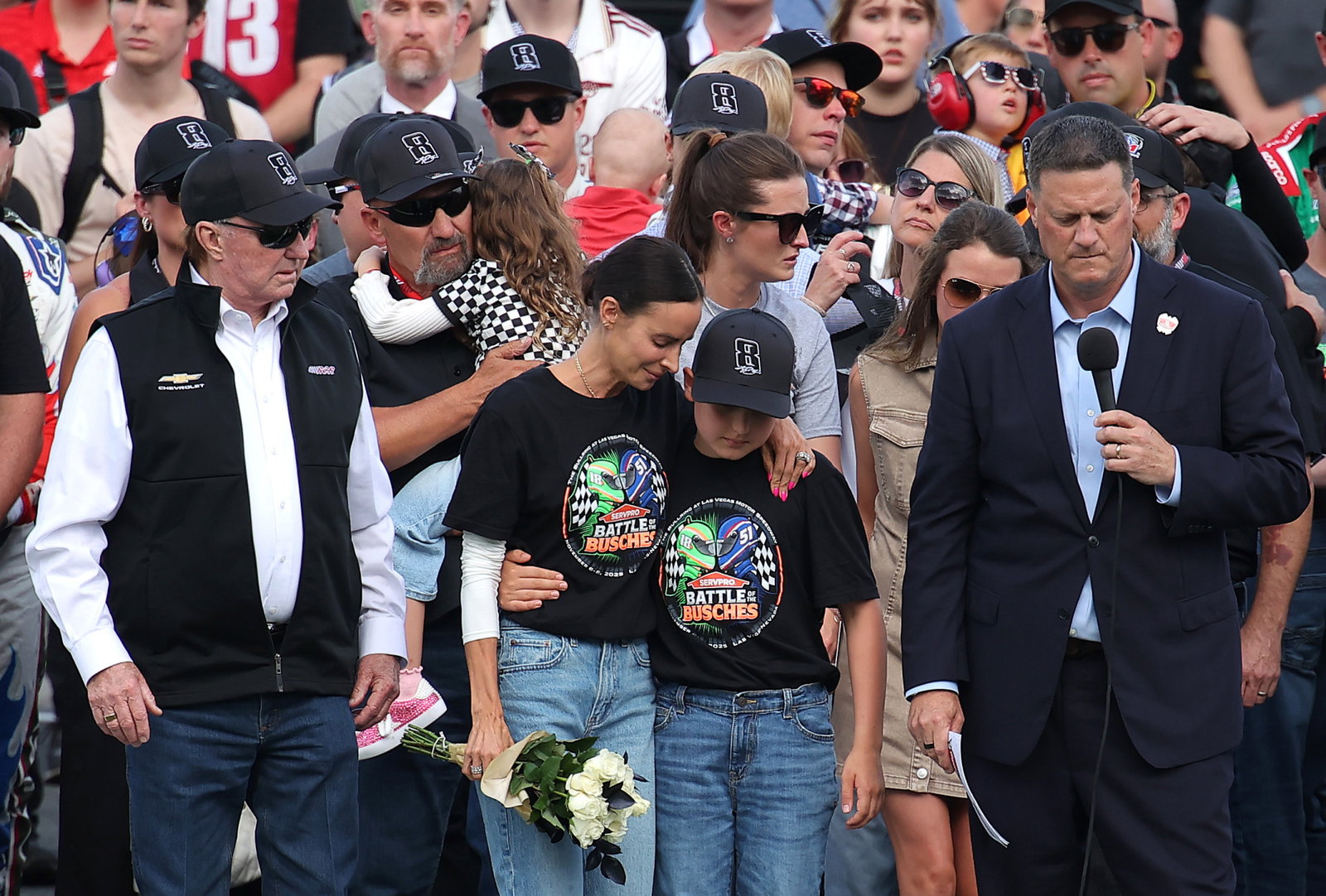 (Left to right) NASCAR Hall of Famer and RCR team owner, Richard Childress, Samantha Busch (wife) Brexton Busch (son) and NASCAR Chief Executive Officer Steve O’Donnell stand on the grid during the remembrance ceremony for Kyle Busch.