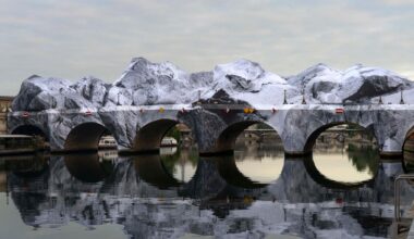 JR’s installation draping the Pont Neuf in Paris draws crowds