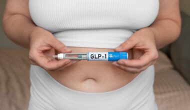Close-up of woman holding GLP-1 injection pen near stomach, modern medical treatment for weight loss and blood sugar control