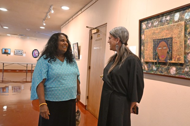 Marin County employees Supriya Menon, left, and Juliet Schiller chat in the third-floor art gallery at the Marin County Civic Center in San Rafael, Calif., on Monday, May 18, 2026. They each contributed a self-portrait for "The Art of Public Service," an exhibit at the gallery. (Alan Dep/Marin Independent Journal)
