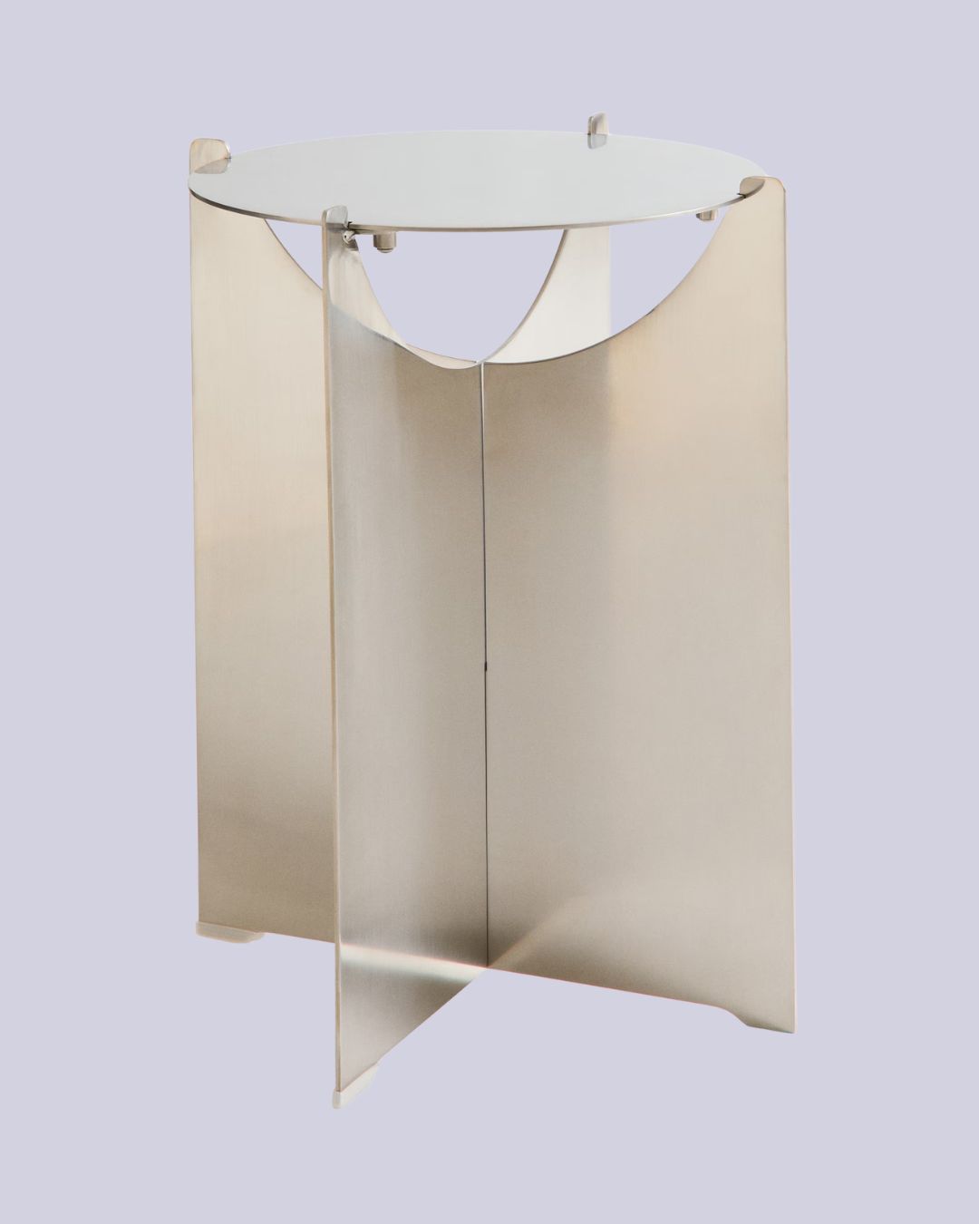 Metal Side Table with sleek, intersected silhouette against pale purple background.