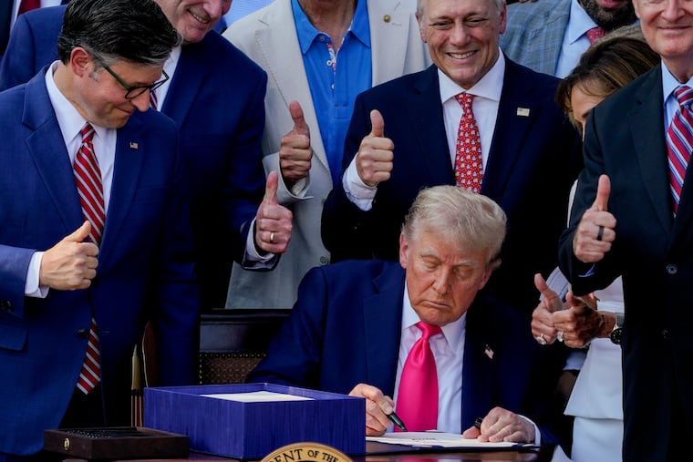 President Donald Trump signs the One Big Beautiful Bill Act at the White House on July 4 as House Speaker Mike Johnson and other Republicans look on. The law includes the creation of an IRA savings option for children.