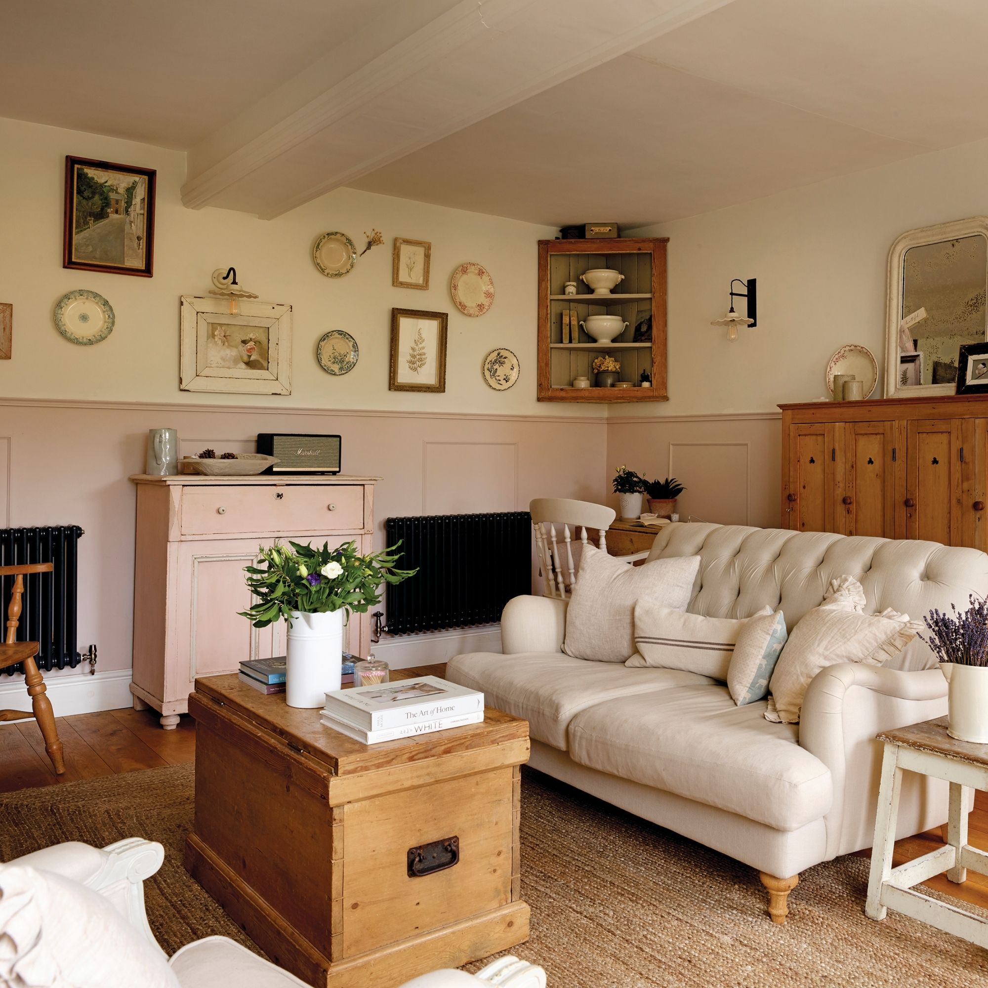 Keen family home sitting from another angle with pink panelling and a wooden trunk coffee table