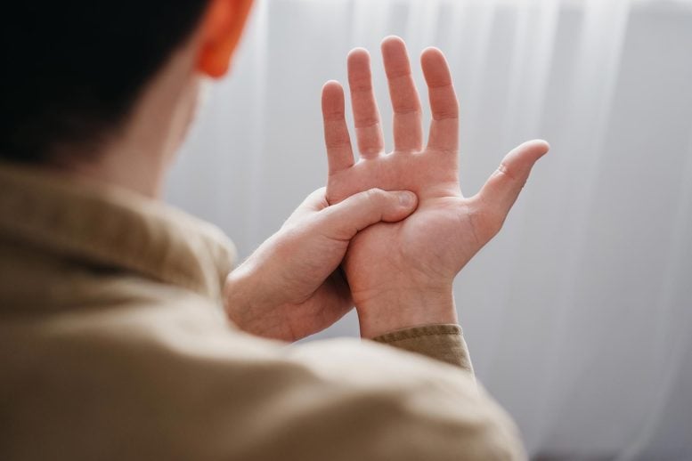 Parkinson's Tremors Man Holding Own Hand