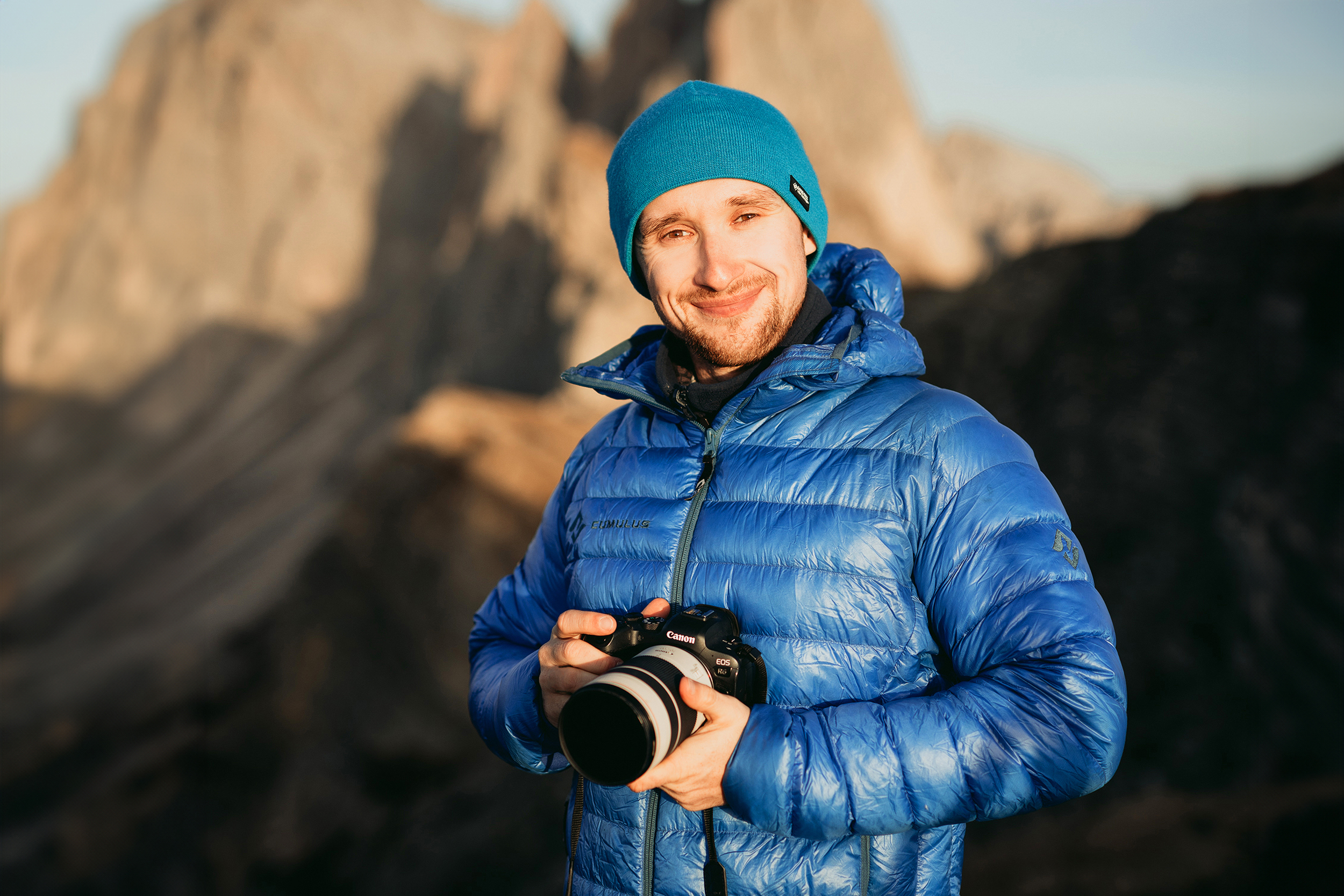 A headshot of photographer Paweł Uchorczak in golden light