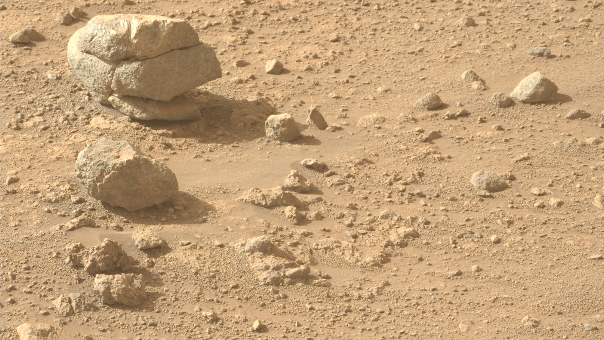 a large stone is cracked in such a way as to appear like three stones stacked on one another
