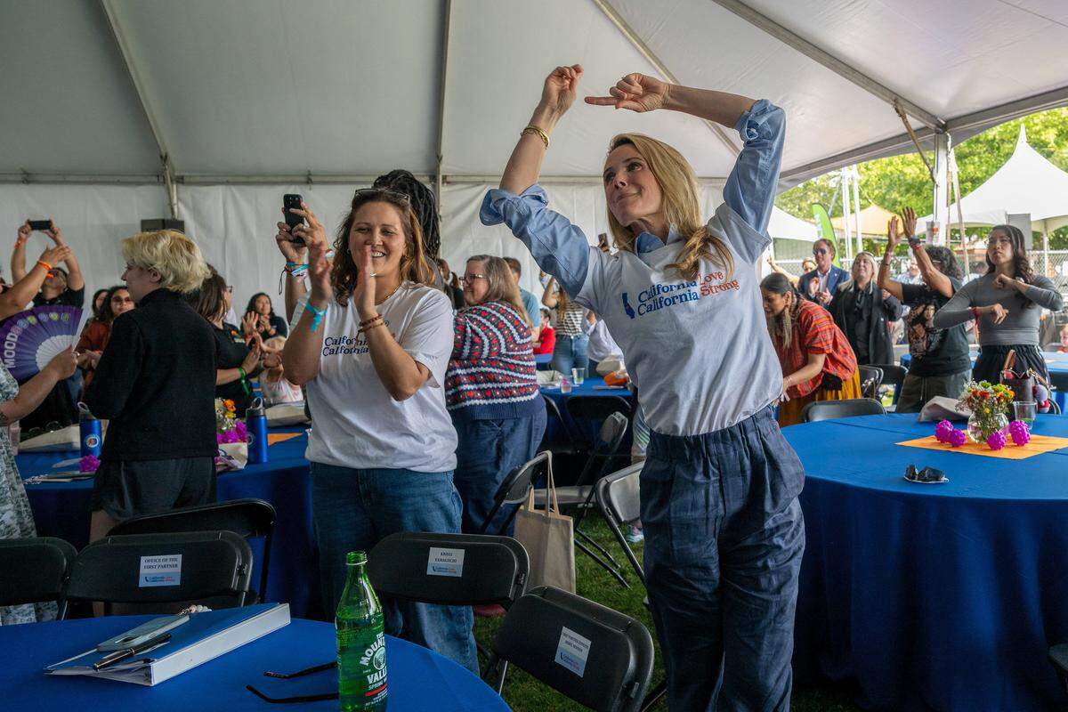 First Partner Jennifer Siebel Newsom dances during an event celebrating the Move Your Body, Calm Your Mind campaign at Street Soccer USA in Sacramento on Friday. The initiative encourages Californians of all ages to increase their physical activity and improve their mental well-being.