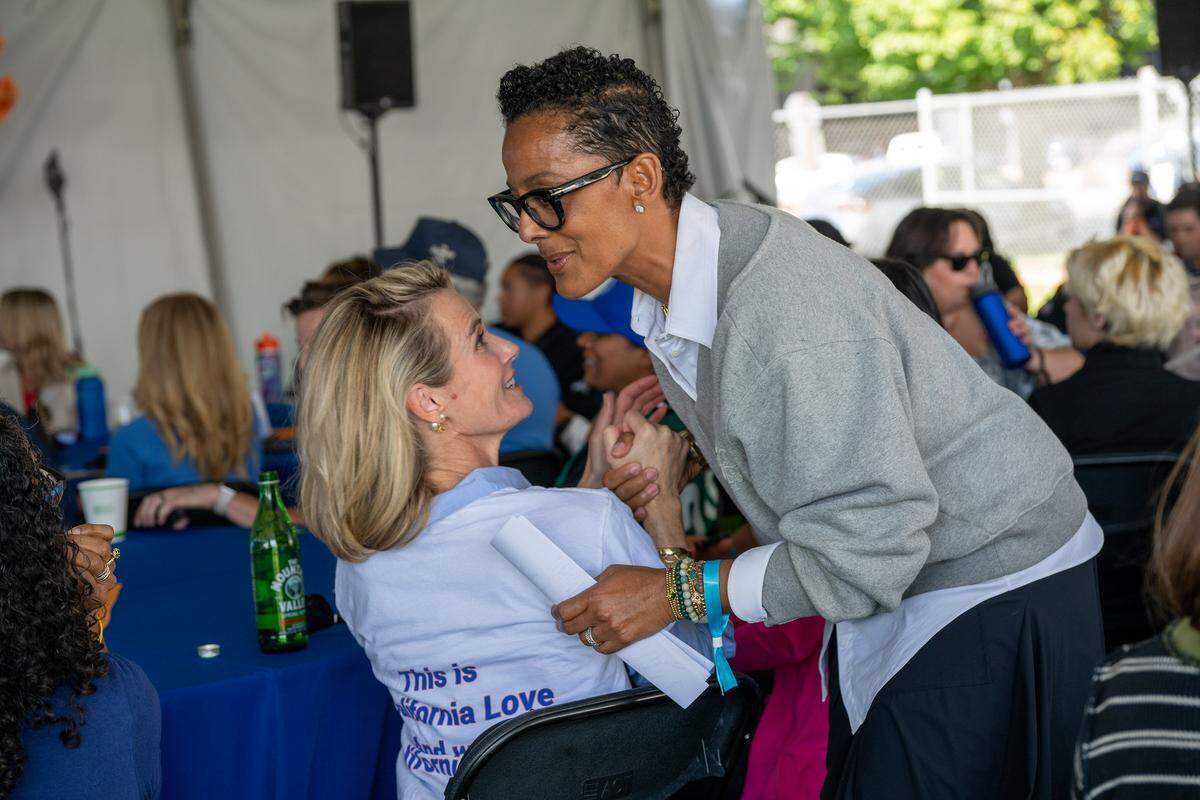 First Partner Jennifer Siebel Newsom, left, and Renata Simril, president and CEO of Vast Foundation, attend an event celebrating Move Your Body, Calm Your Mind campaign at Street Soccer USA in Sacramento on Friday. Both spoke during the event. The initiative encourages Californians of all ages to increase their physical activity and improve their mental well-being.