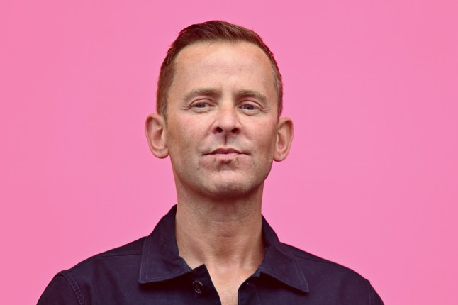 Scott Mills presents the Radio 2 in the Park, against a pink background.