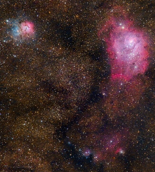 Swirls of bright, electric blue and pink nebulosity, over an extremely rich background of colored stars.