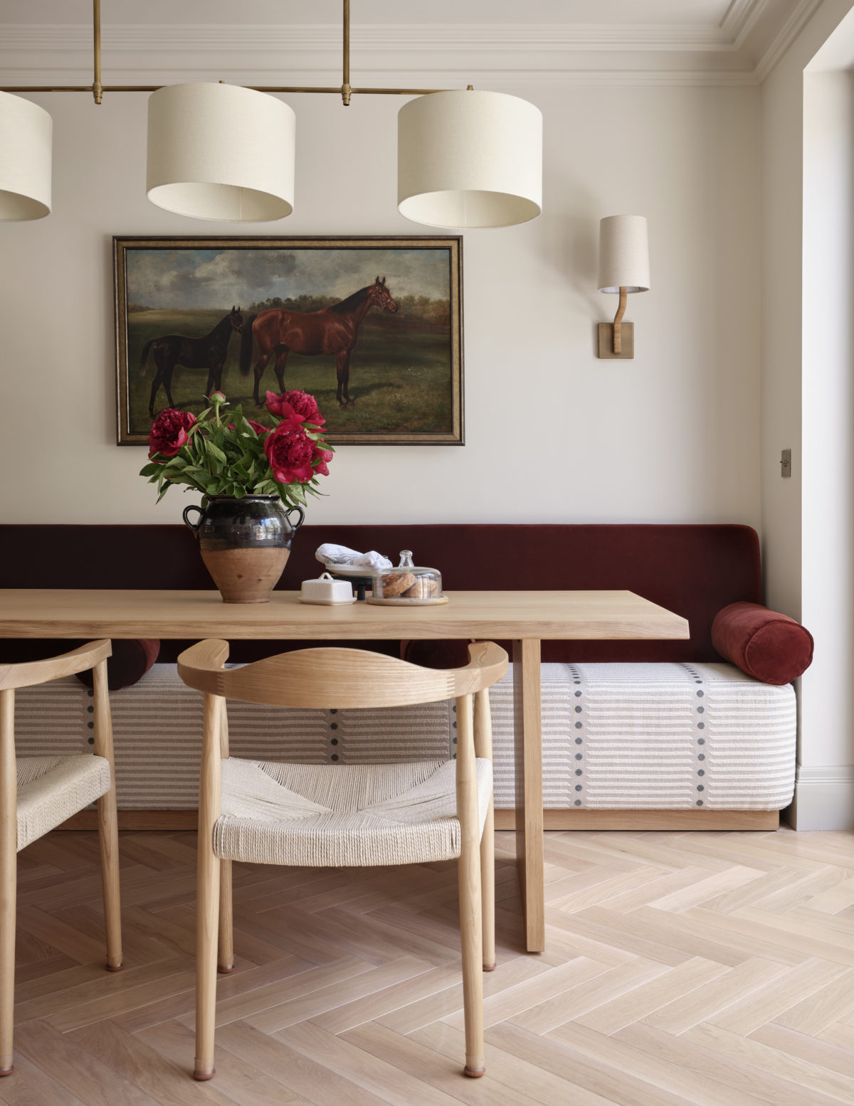 a dining room with a red velvet banquettee seat