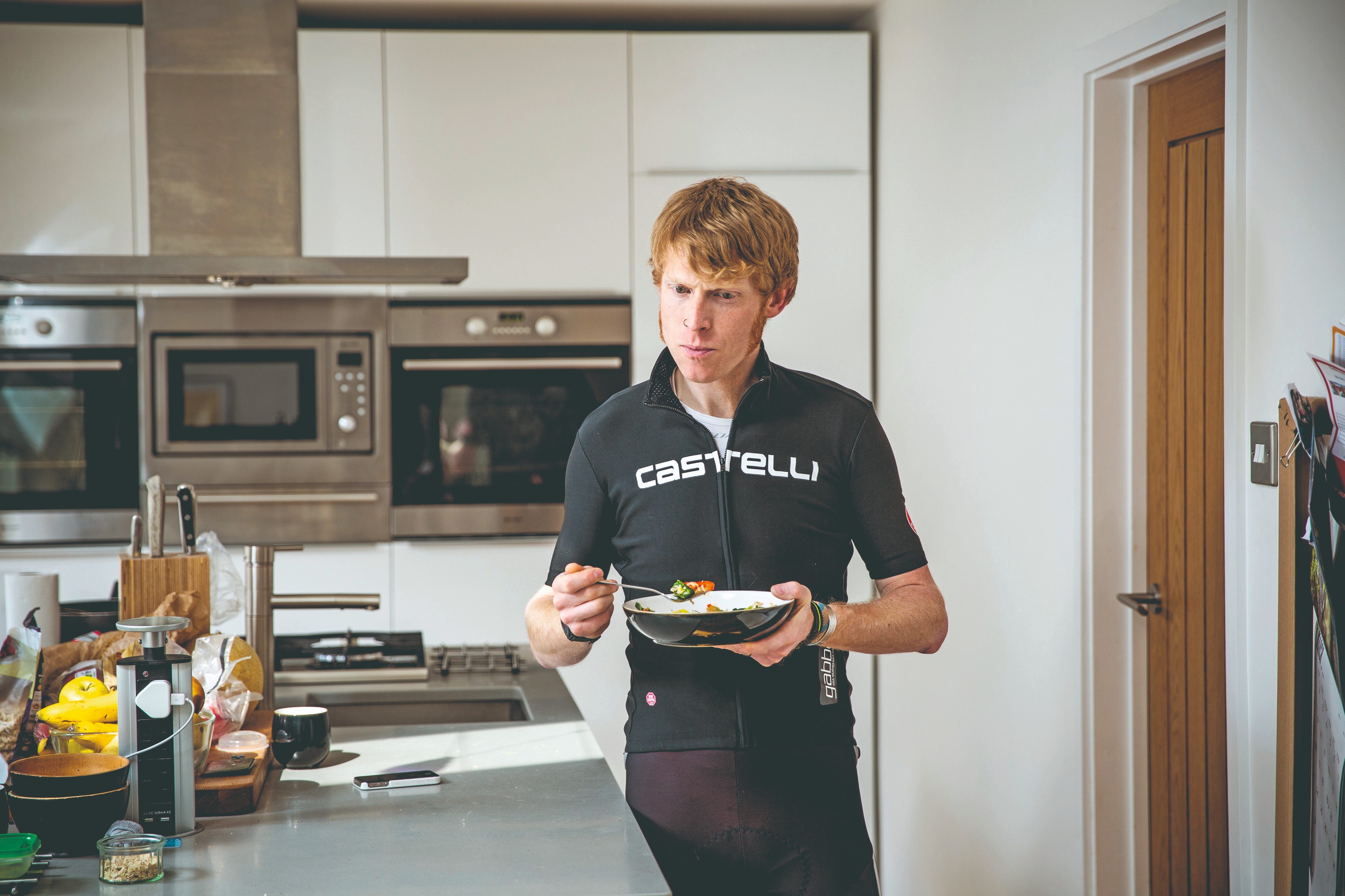 cyclist eating food in the kitchen