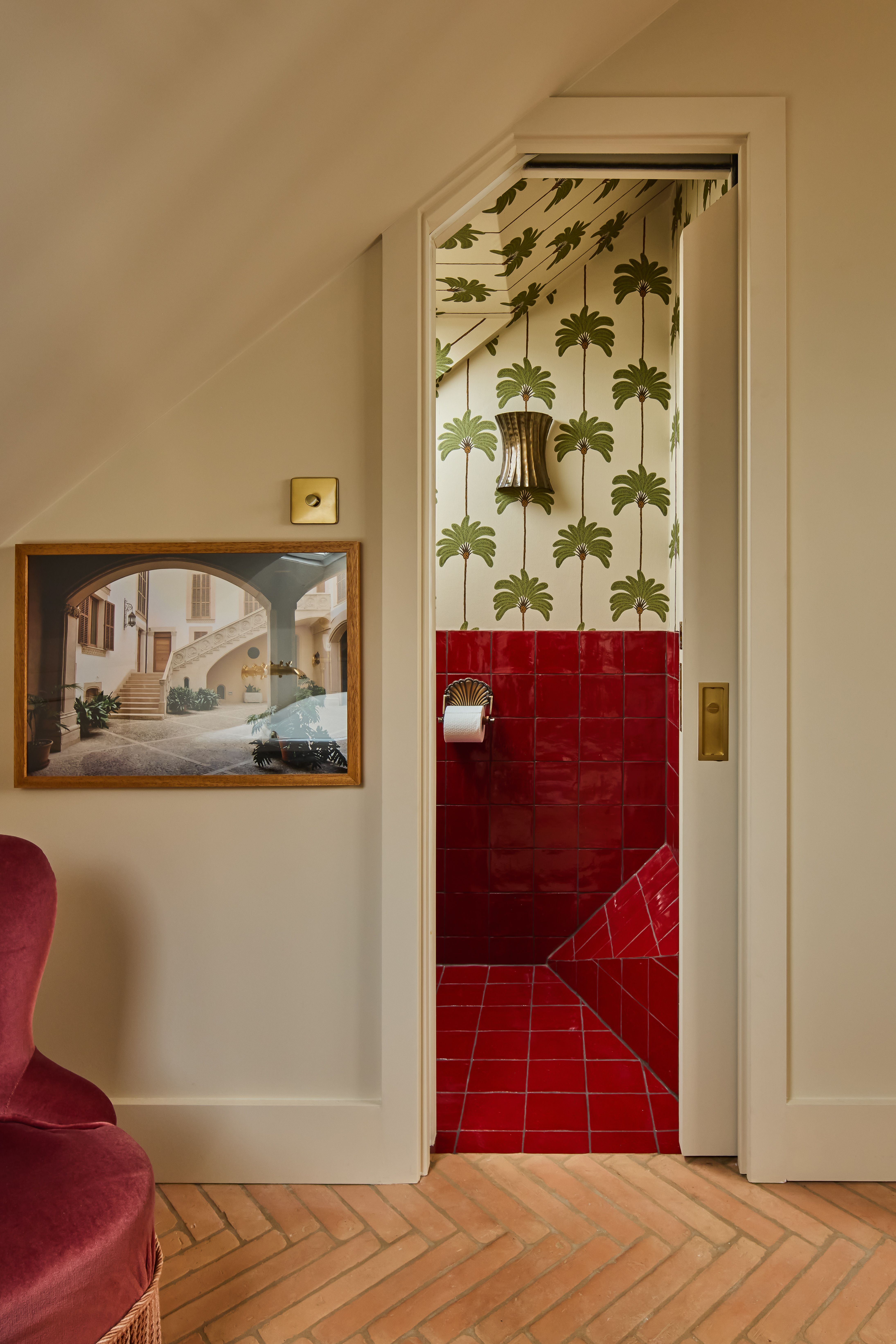 red tiled ensuite bathroom viewed through a door in a loft conversion