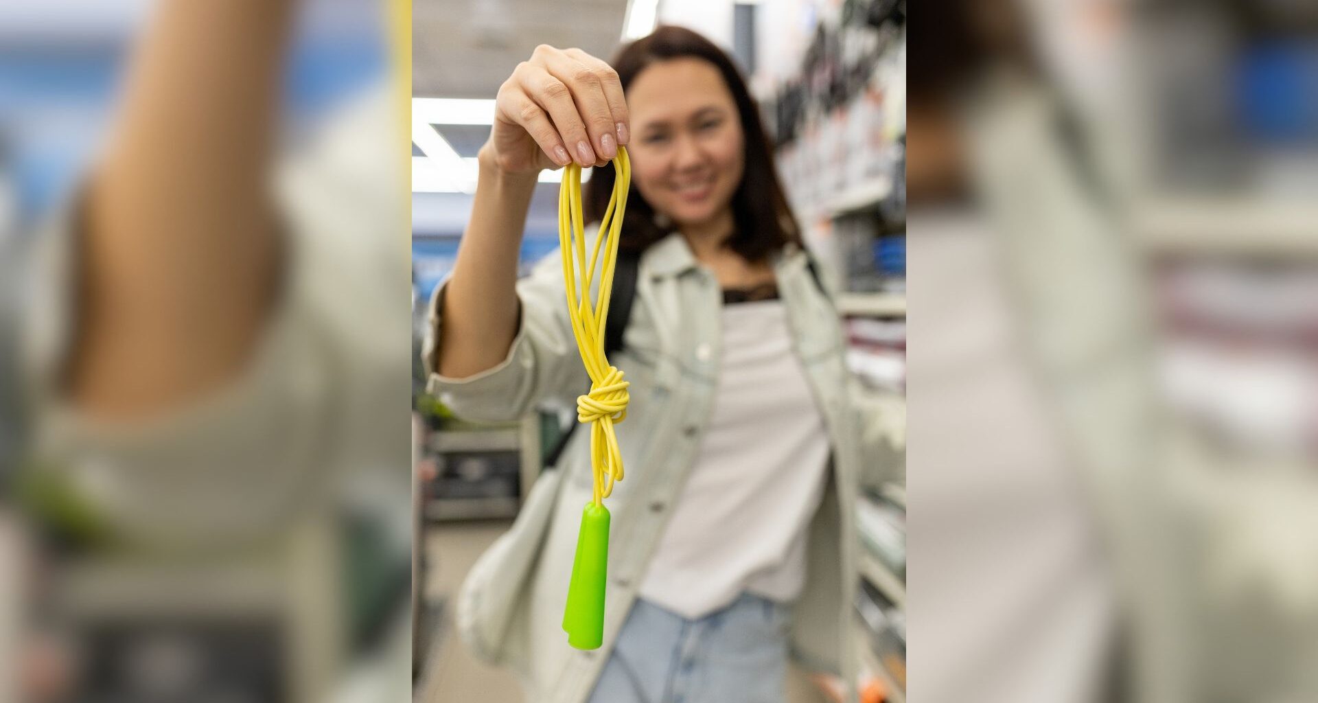 Woman holds up jump rope in store