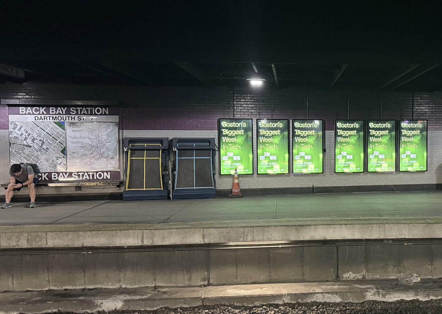 Advertisements for Boston Tech Week in the Back Bay MBTA station.