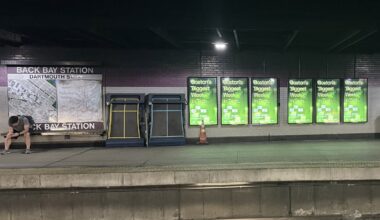 Advertisements for Boston Tech Week in the Back Bay MBTA station.