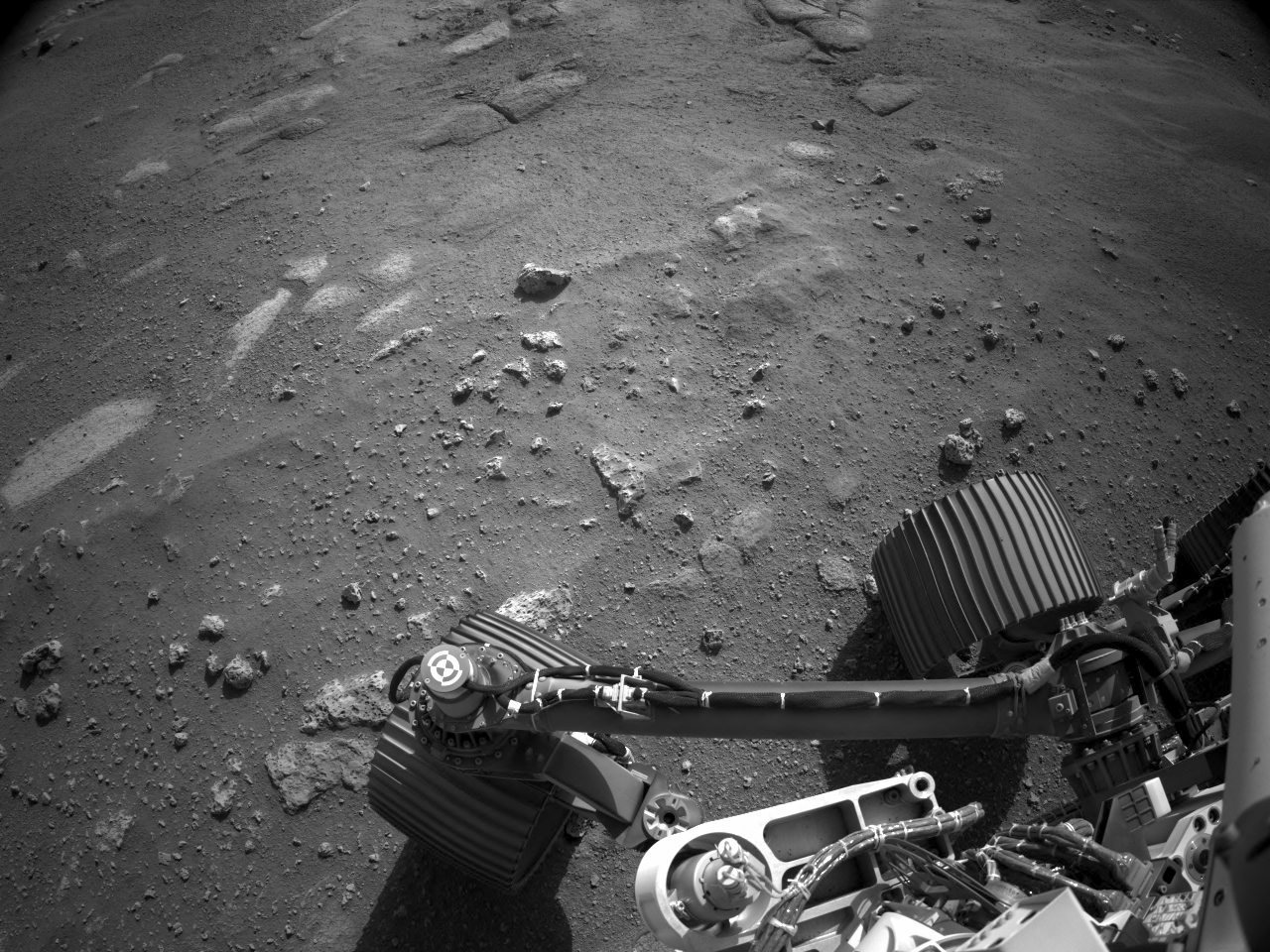 ridged wheels on a dusty, rocky surface