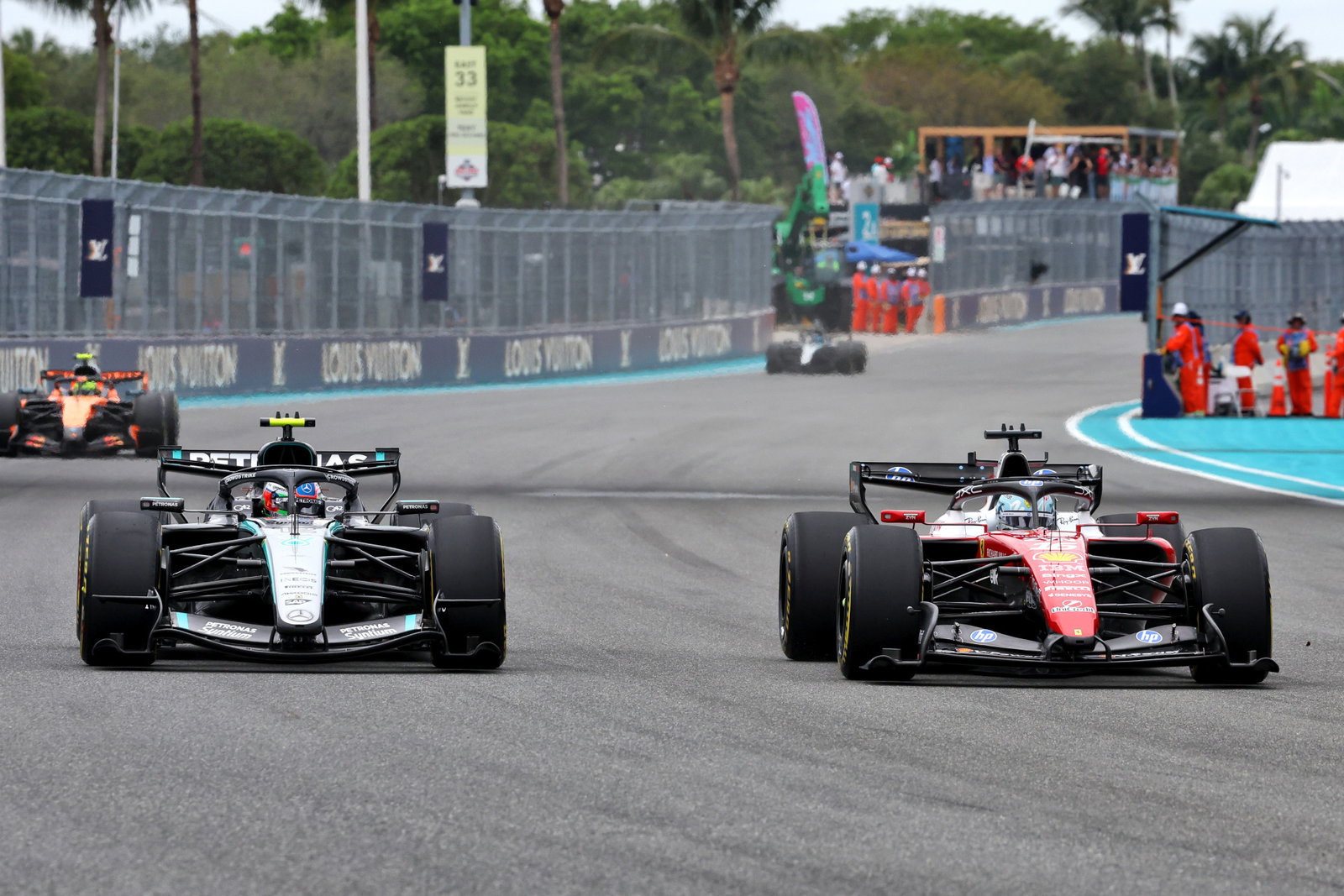 Kimi Antonelli (left) and Charles Leclerc jockey over position with Lando Norris behind them during the Miami Grand Prix.