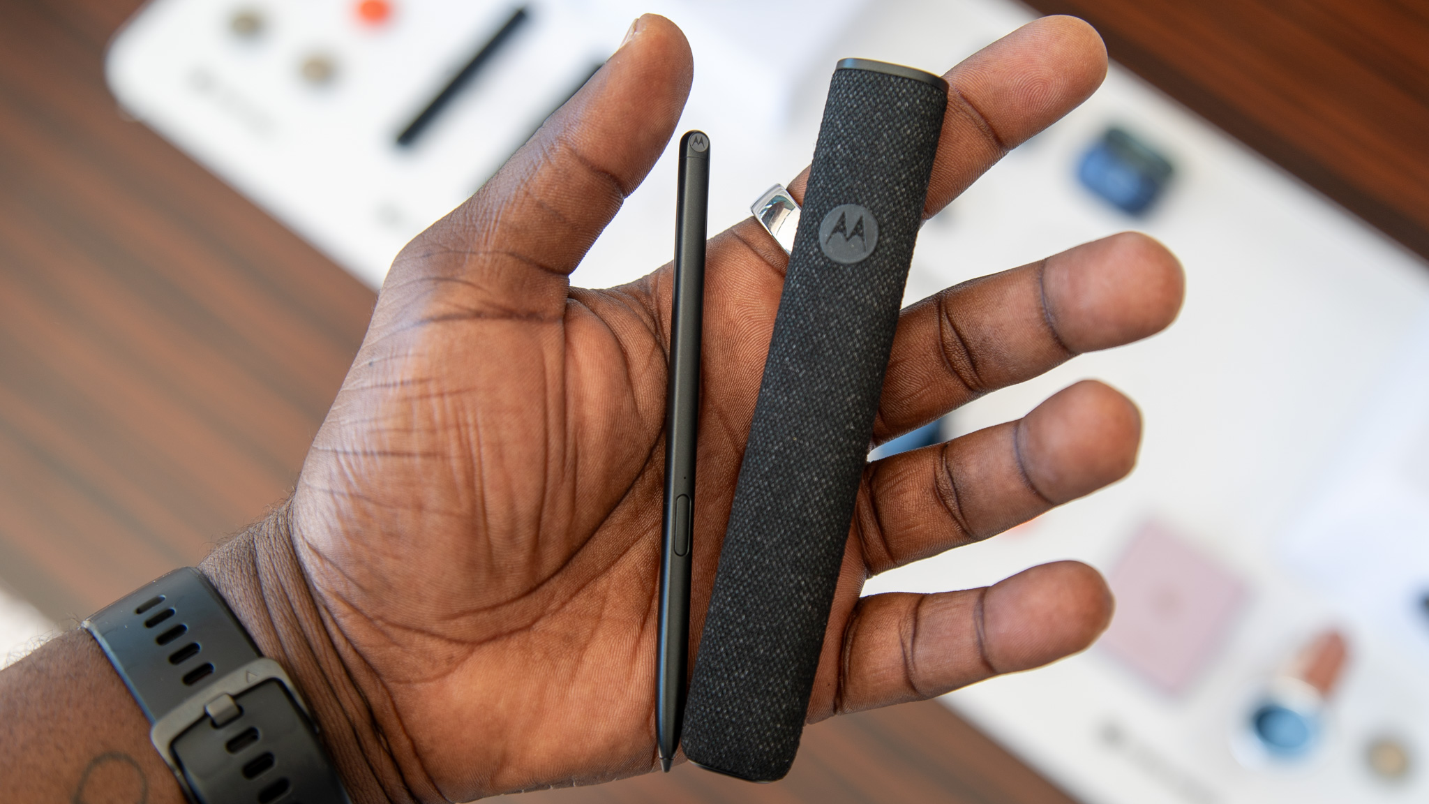 Moto Pen Ultra in hand next to its case