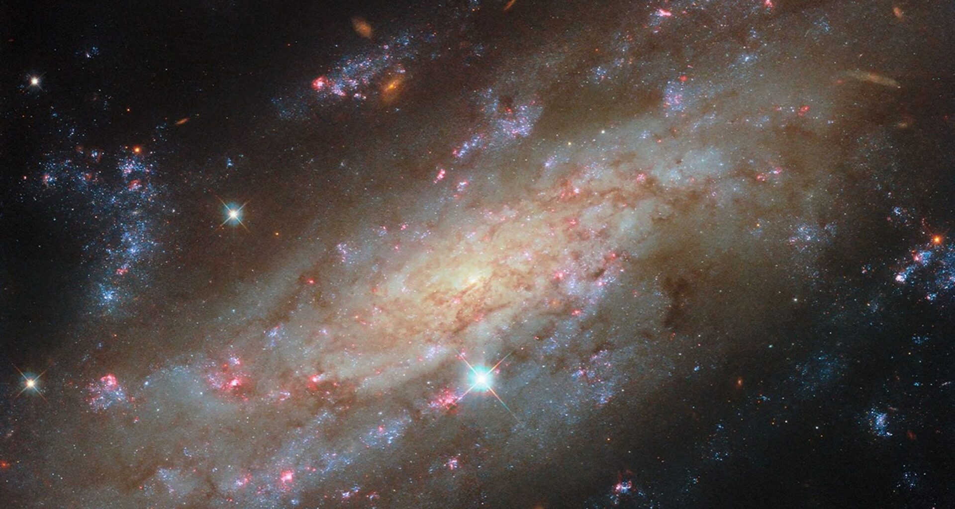Clusters of bright blue stars and glowing red gas clouds steal the show in this new Hubble image of a glittering galaxy that stopped me in my tracks
