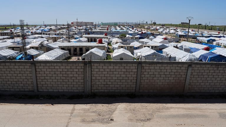 A brick wall surrounds a tent camp housing people with alleged ties to Islamic State militants at Roj Camp in eastern Syria.