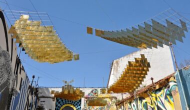 kinetic mirrored installation in portugal by moradavaga evokes a shoal of golden fish