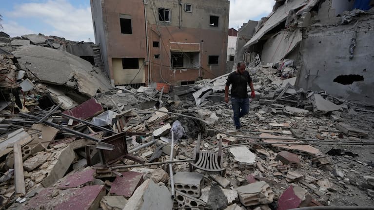 A man walks between destroyed buildings that were hit in Israeli airstrikes in Burj al-Shemali village near the southern port city of Tyre, Lebanon, Tuesday, May 26, 2026.