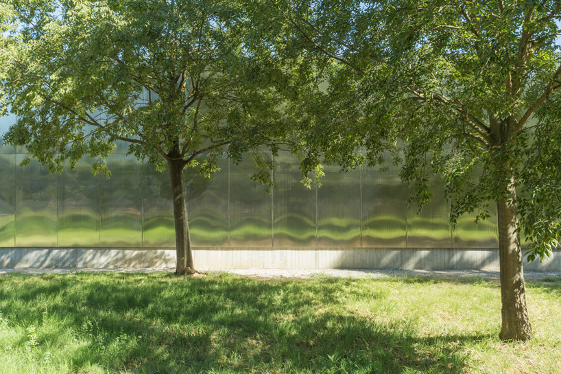 mirrored aluminum facade blurs distretto solidale social space into the italian landscape - 3