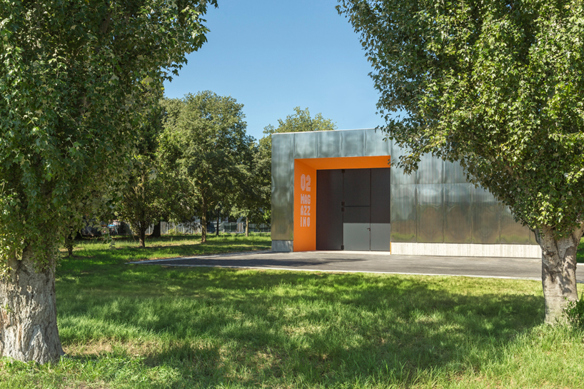 mirrored aluminum facade blurs distretto solidale social space into the italian landscape - 1