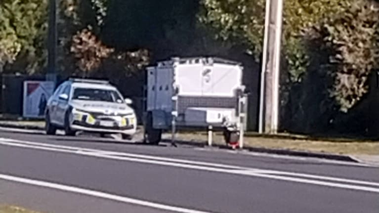 A police vehicle parked behind the speed camera trailer unit on Saturday.