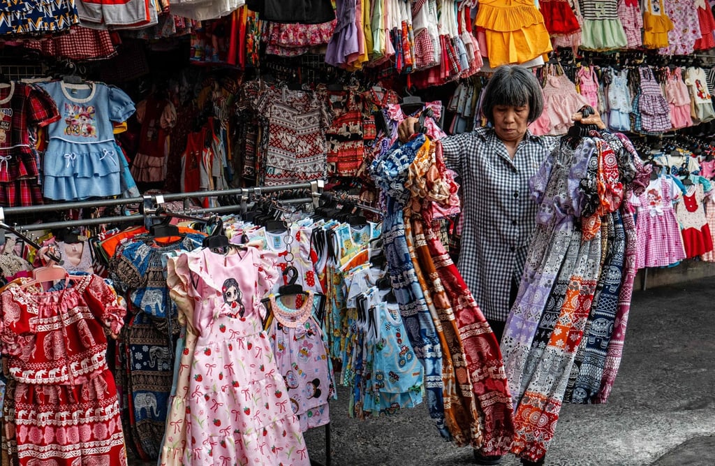 A vendor prepares her displays as she opens up for business at Mahanak Market in Bangkok on April 20. Photo: AFP