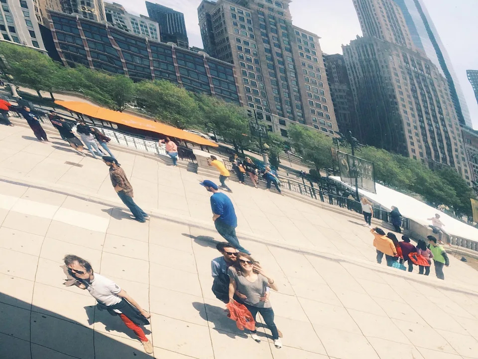 The author and her now-husband take a picture of their reflection at the Cloud Gate in Chicago.