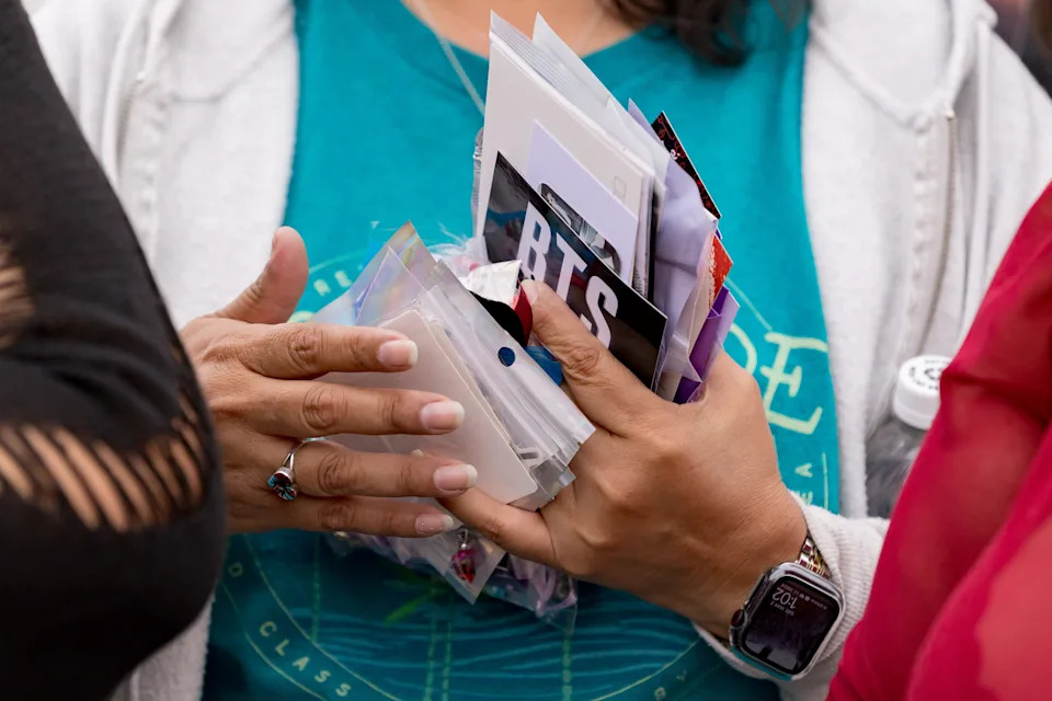 A BTS fan holds the freebies she has collected outside the Sun Bowl in El Paso, Texas, on Saturday, May 2, 2026, before the first concert.