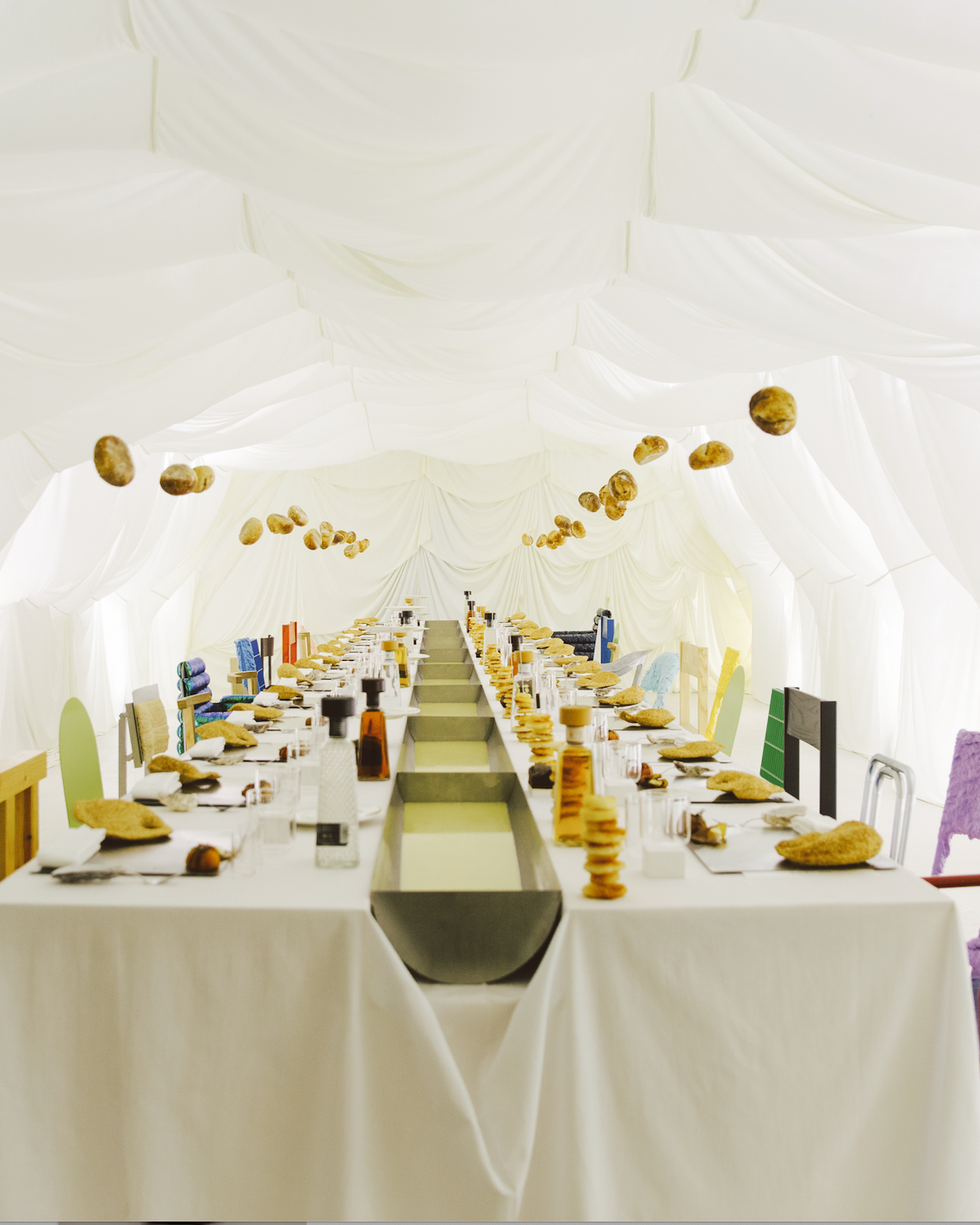 Long dining table set for a meal.