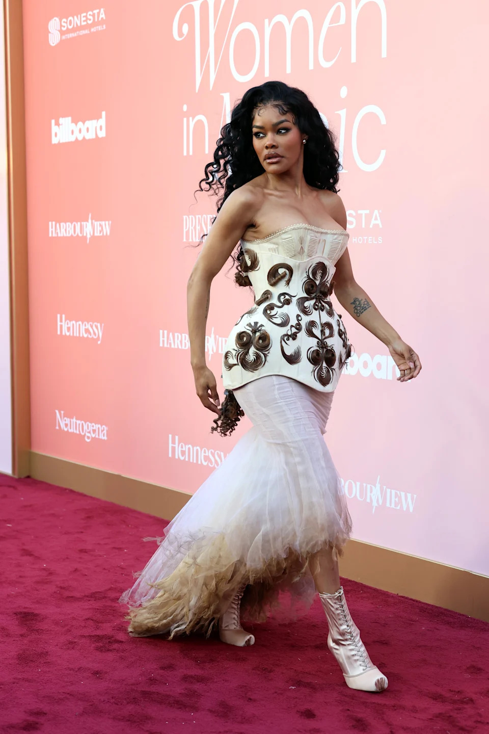 Teyana in an elaborate, form-fitting gown with intricate hair details