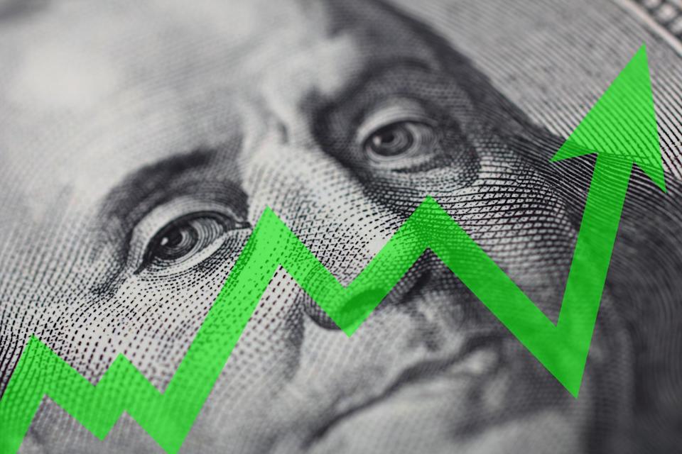 An upward-trending green arrow with Benjamin Franklin's face in the background.