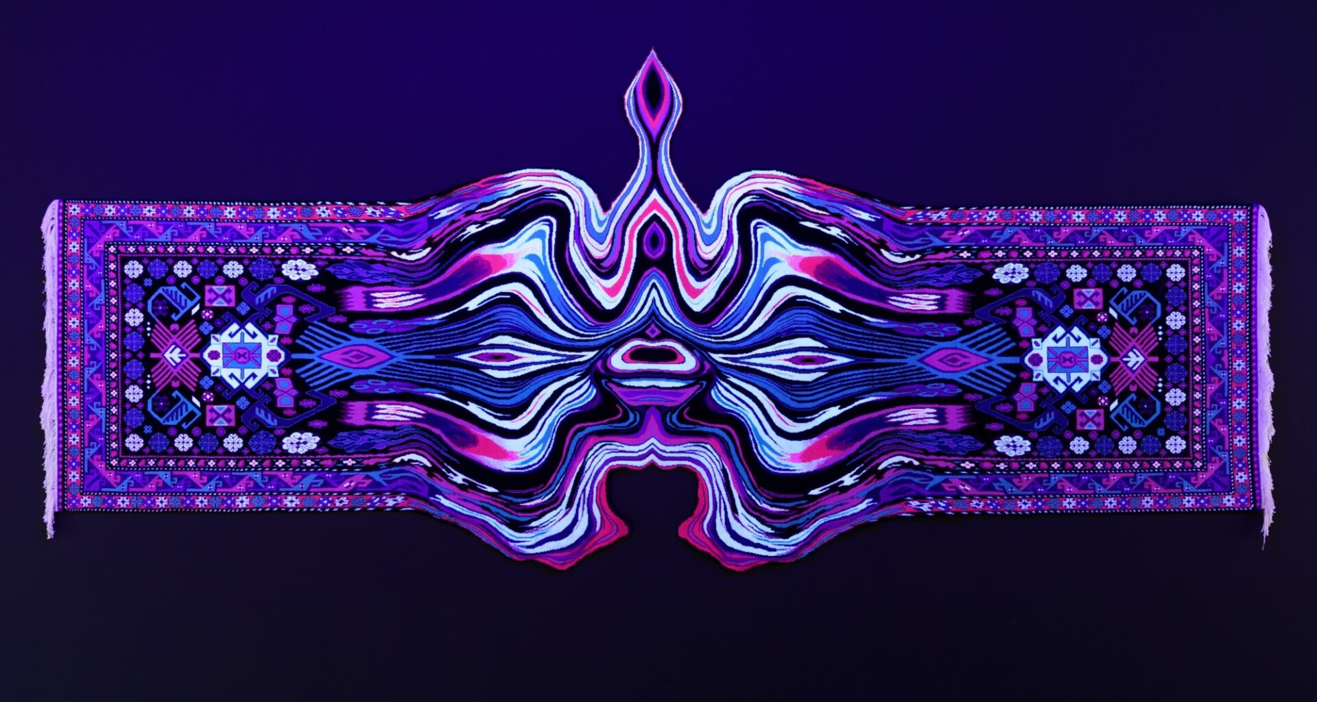 a handmade wool carpet illuminated by a black light on a wall with a symmetrical, undulating, psychedelic form in the middle