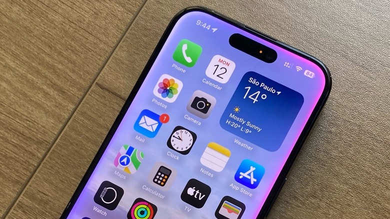 An iPhone on an office table with the Apple Intelligence interface on its display