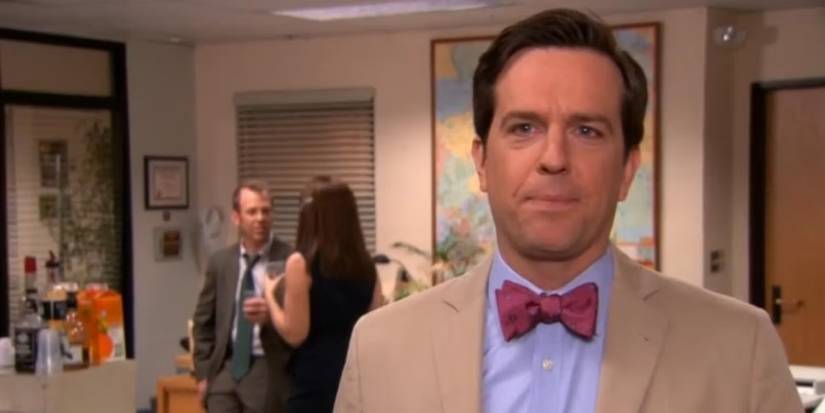 Andy (Ed Helms) talking to the camera, with Toby and Meredith talking behind him, in The Office finale.