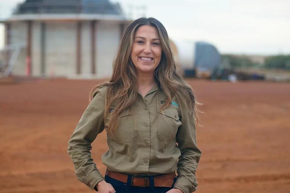 Starsite's Angela Teale in front of the antenna being built.