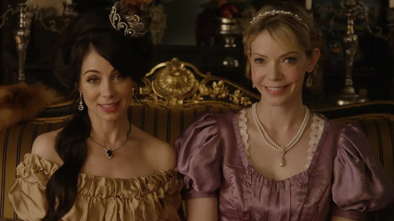 Natasha Leggero and Riki Lindhome as Lillian and Beatric talking to the camera in Another Period