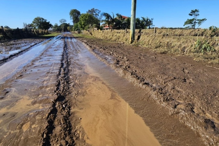 A country road covered in a thick layer of mud after a flood in a country town.